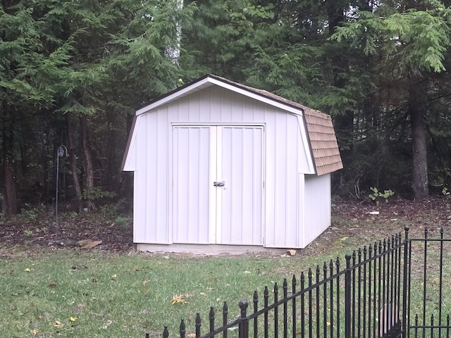 view of outbuilding featuring a lawn