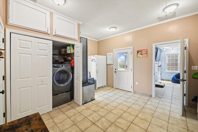 laundry room featuring a textured ceiling, laundry area, ornamental molding, and washer / dryer