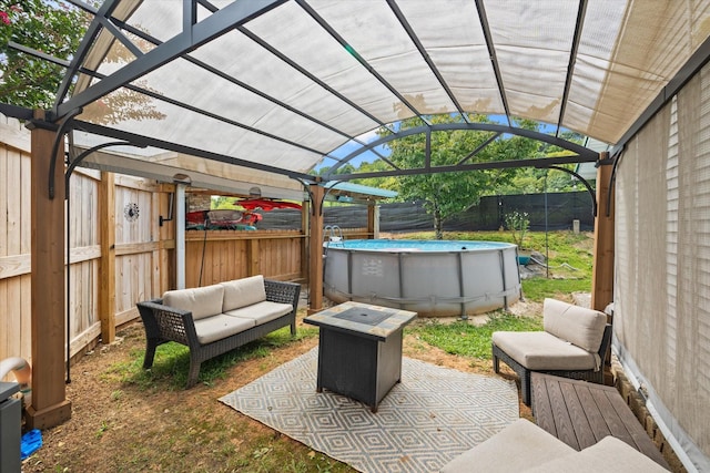 view of patio / terrace with a fenced backyard, an outdoor pool, and a pergola