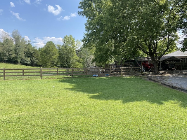 view of yard with a rural view and fence