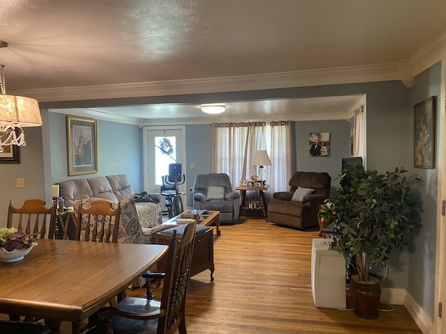 dining room featuring crown molding and light hardwood / wood-style floors