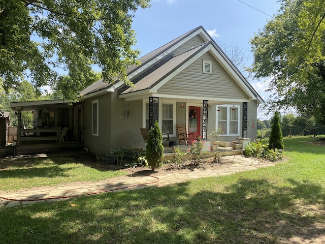 view of front of property with covered porch and a front yard