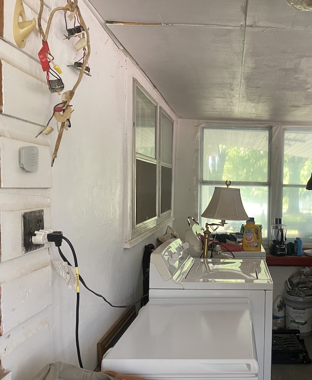 clothes washing area with washer and dryer