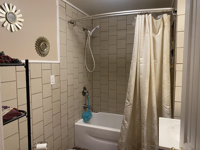 full bathroom with tile walls and shower / bathtub combination with curtain