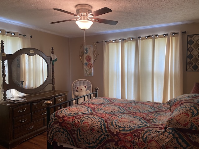 bedroom featuring hardwood / wood-style flooring, a textured ceiling, and ceiling fan