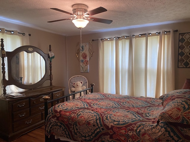 bedroom featuring crown molding, a textured ceiling, and wood finished floors