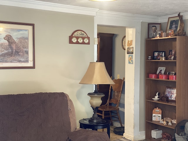 bedroom with ornamental molding and a textured ceiling