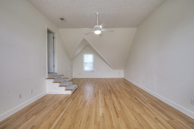 bonus room with ceiling fan, light hardwood / wood-style floors, and lofted ceiling