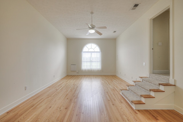 empty room featuring light hardwood / wood-style flooring and ceiling fan