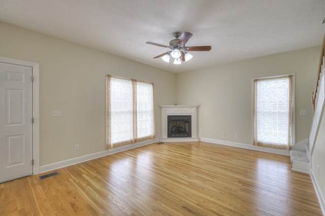 unfurnished living room with light hardwood / wood-style flooring and ceiling fan