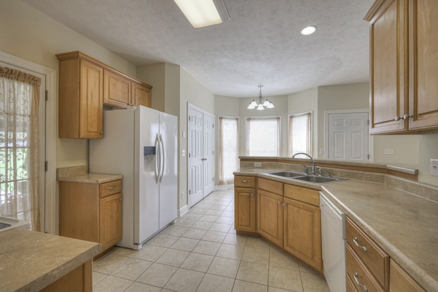 kitchen featuring a chandelier, sink, a textured ceiling, light tile patterned floors, and white appliances