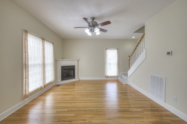 unfurnished living room with ceiling fan and light hardwood / wood-style floors