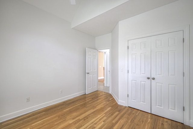 unfurnished bedroom featuring a closet, ceiling fan, and hardwood / wood-style floors