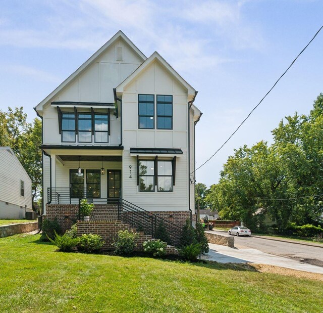 view of front of property with a porch and a front lawn