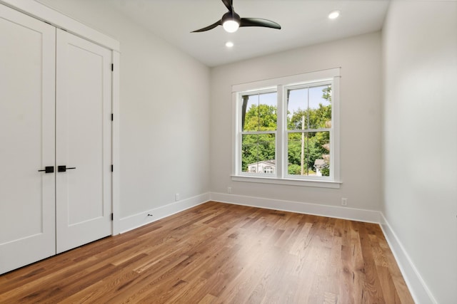 empty room featuring ceiling fan, recessed lighting, light wood-type flooring, and baseboards