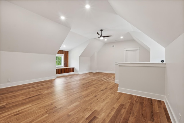 bonus room with ceiling fan, vaulted ceiling, baseboards, and wood finished floors