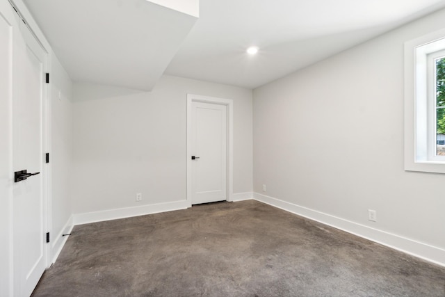 interior space featuring concrete flooring and baseboards