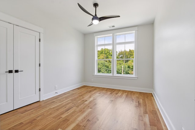 unfurnished bedroom with light wood finished floors, baseboards, and visible vents