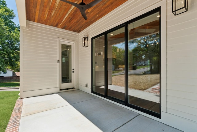 property entrance with a ceiling fan and a patio