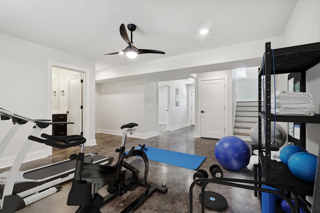 exercise area with ceiling fan and baseboards