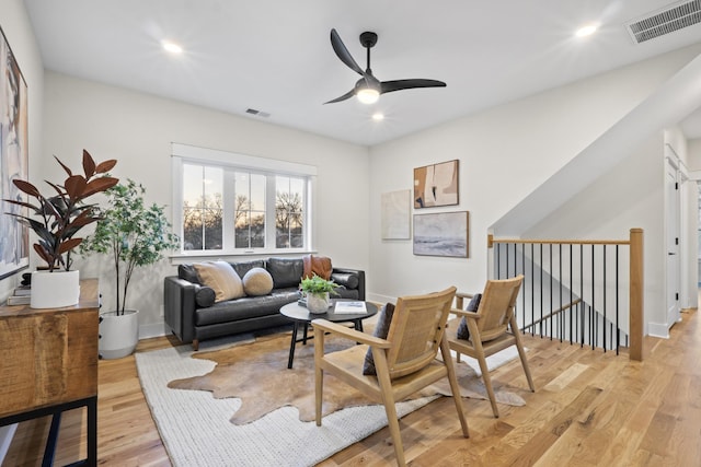 living area featuring recessed lighting, an upstairs landing, baseboards, visible vents, and light wood finished floors