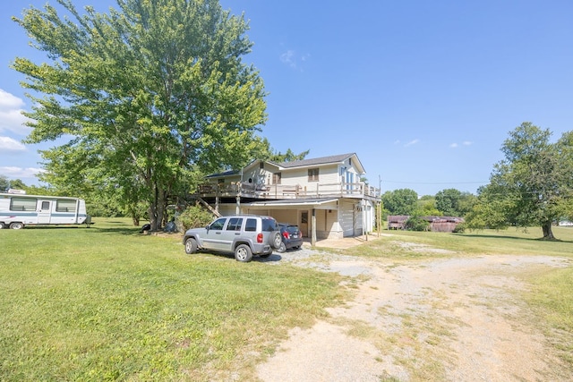 view of front of house with a front yard, a deck, and a garage