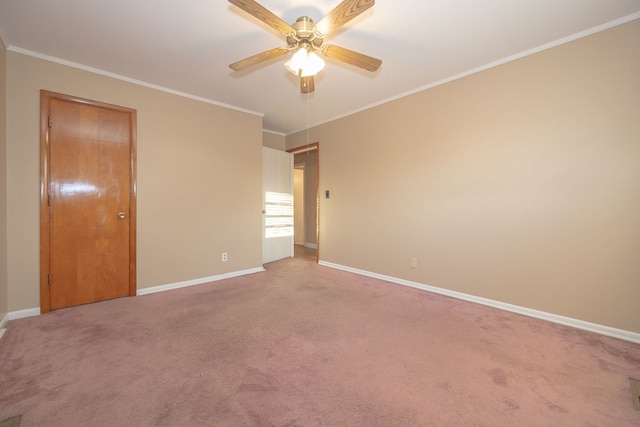 carpeted spare room featuring ceiling fan and crown molding