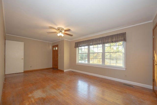 spare room featuring crown molding, ceiling fan, and light hardwood / wood-style floors