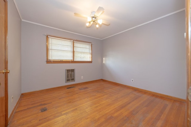 unfurnished room featuring heating unit, crown molding, ceiling fan, and light wood-type flooring