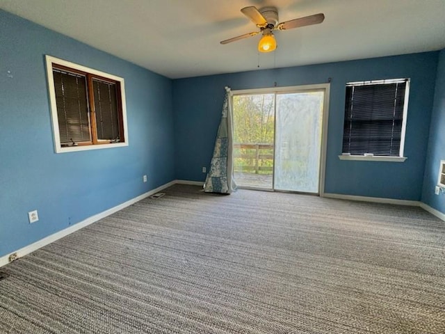 carpeted empty room featuring ceiling fan