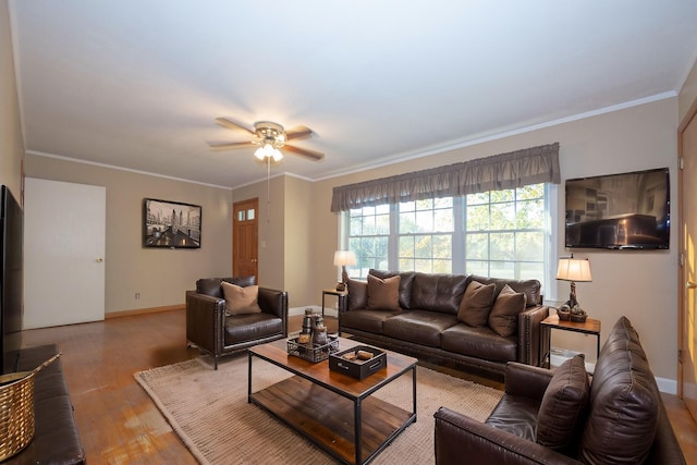 living room with light wood-type flooring, ceiling fan, and ornamental molding