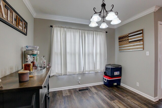 dining area featuring dark wood-type flooring, a chandelier, and ornamental molding