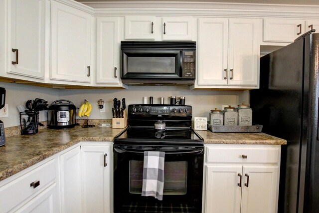 kitchen featuring light stone counters, white cabinets, and black appliances