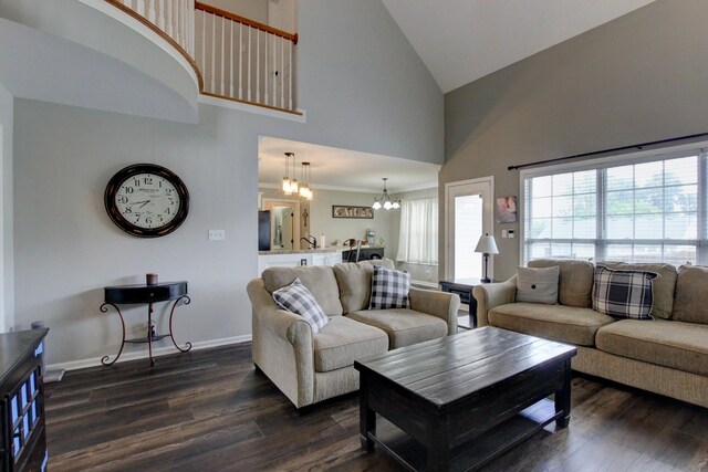 living room featuring a high ceiling, a notable chandelier, and dark wood-type flooring