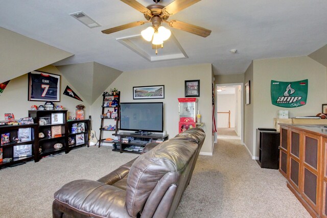 carpeted living room with ceiling fan and lofted ceiling