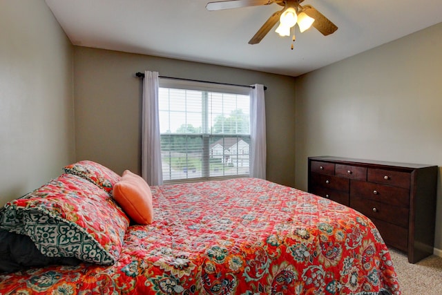 bedroom with ceiling fan and light colored carpet