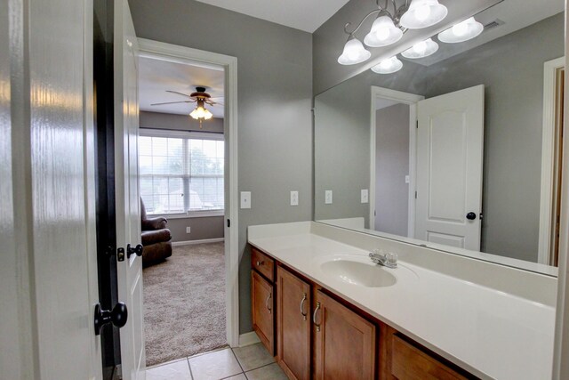 bathroom with tile patterned floors, vanity, and ceiling fan