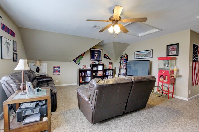 carpeted living room with ceiling fan and vaulted ceiling