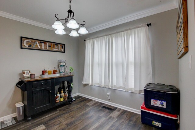 interior space with ornamental molding, dark hardwood / wood-style flooring, and an inviting chandelier