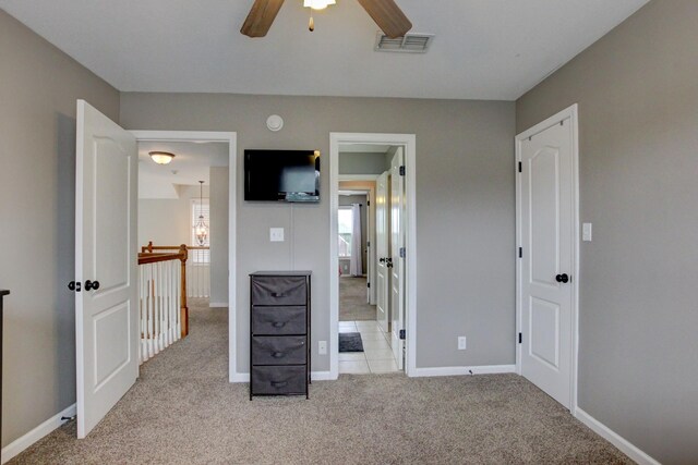 unfurnished bedroom featuring ceiling fan and light carpet