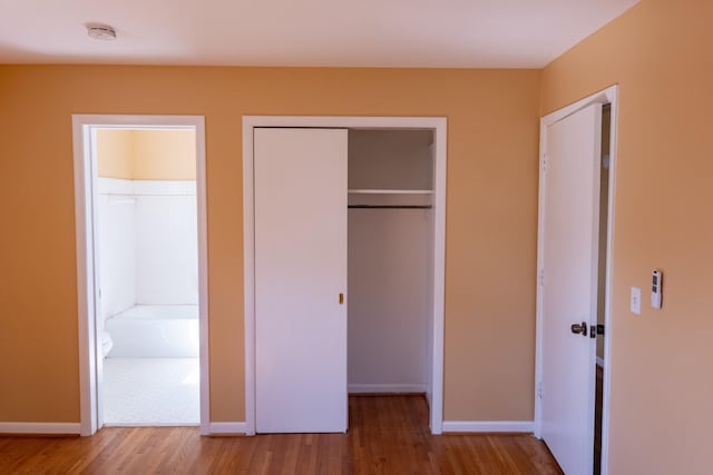 unfurnished bedroom featuring baseboards and wood finished floors