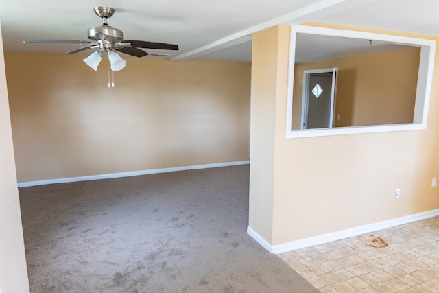 spare room featuring baseboards, carpet, and ceiling fan