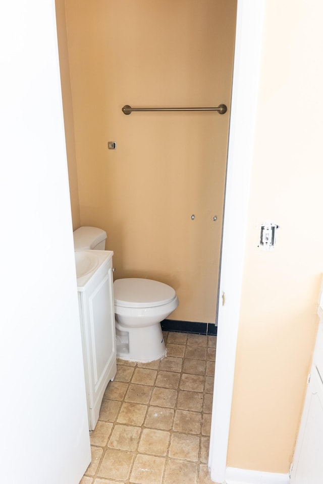 bathroom with toilet and baseboards