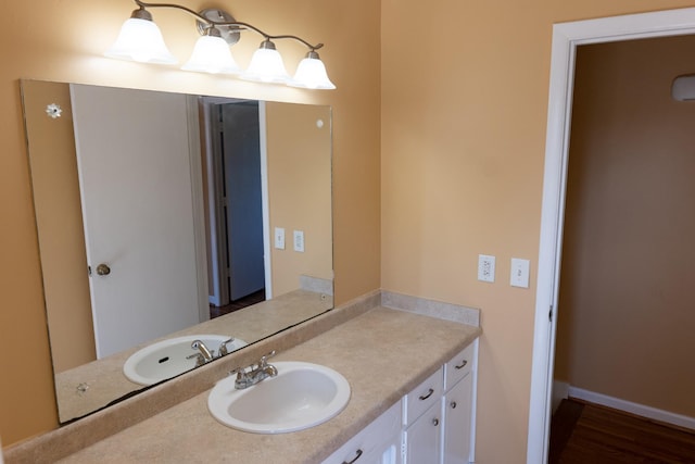 bathroom with baseboards and vanity