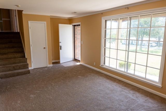 unfurnished room with stairs, baseboards, carpet, and crown molding