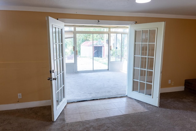 doorway featuring tile patterned floors, carpet, and french doors