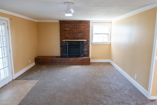 unfurnished living room featuring carpet flooring, a fireplace, and baseboards