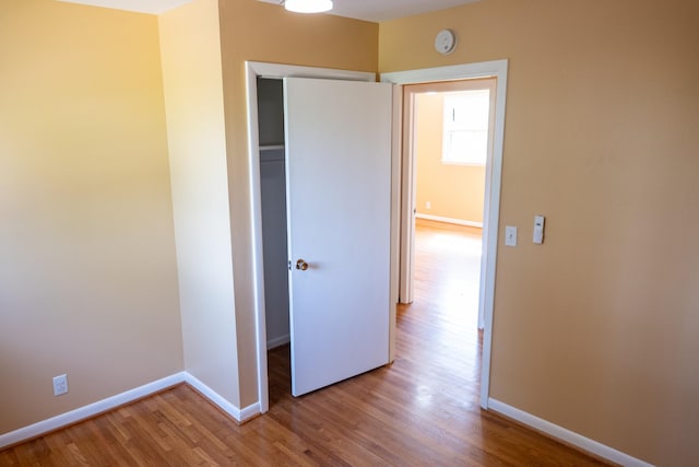 unfurnished bedroom with baseboards and wood finished floors