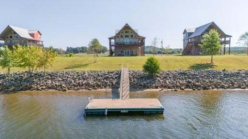 dock area featuring a yard and a water view