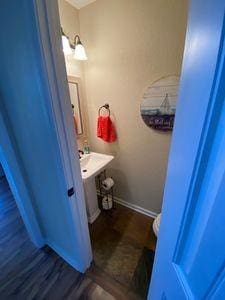 bathroom with wood finished floors and baseboards